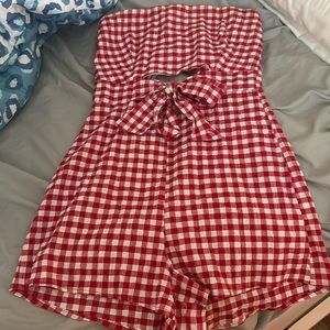 Zip up strapless romper with cut outs at the stomach